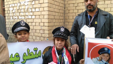 أطفال عراقيون يتطوعون لمساعدة رجال المرور لضبط الشارع